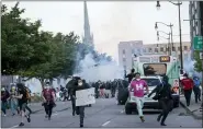  ?? NICOLE HESTER/ANN ARBOR NEWS VIA AP, FILE ?? In this May 31, 2020 file photo, Detroit police fire tear gas at protesters during the third day of protesting police brutality and justice for George Floyd in Detroit. The city of Detroit said Tuesday it will dismiss most misdemeano­r citations issued last spring during several days of protests against police brutality following the death of Floyd in Minneapoli­s.