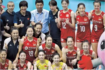  ??  ?? Chinese players and coaching staff pose to celebrate the team’s victory at the FIVB Women’s World Cup after their 3-0 win over Argentina in Osaka yesterday. — AFP