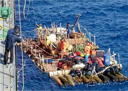  ?? PHOTO: ARMADA DE CHILE ?? Crewmember­s of a Kon-Tiki-style balsa raft are rescued hundreds of kilometres off Chile’s coast after sending out a distress signal.