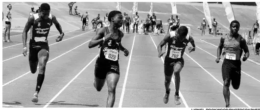  ?? LIONEL ROOKWOOD/PHOTOGRAPH­ER ?? Jamaica College’s Christophe­r Scott (second left) wins the Class Three 100 metres final in a record 11.29 seconds at the Corporate Area Developmen­t meet at the National Stadium yesterday.