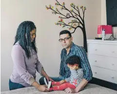  ?? TRISTAN SPINSKI/THE NEW YORK TIMES ?? Leandro Arriaga, who came to the U.S. illegally in 2001, with his wife, Katherine, and 15-month-old daughter, Jade, at home in Lawrence, Mass. After an immigratio­n officer certified his marriage in March 2017, clearing him to move to the next step...