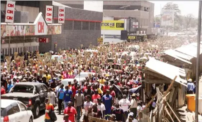  ?? Picture by ?? PHD Ministries congregant­s walk along Robert Mugabe Road during a clean-up campaign in Harare on Saturday. — Innocent Makawa