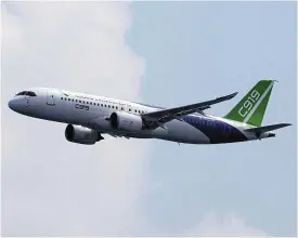  ?? /Reuters ?? On show: A Comac C919 flies past during an aerial flying display before the Singapore Airshow at Changi Exhibition Centre in Singapore on February 18.