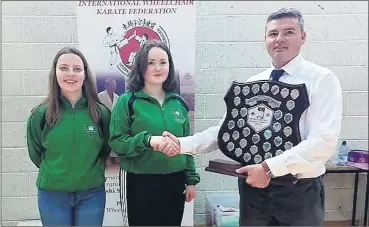  ?? ?? IJKA Ireland Secretary Sensei Joe Hunter presenting the Sensei Jess Pablo Memorial Shield to Senseis Alison Hennessy and Rebecca Walsh.