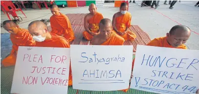  ??  ?? RIGHT Seven monks from Mae Hong Son stage a hunger protest outside the temple opposing the authoritie­s’ plan to raid the temple and the Section 44 order under the interim charter which declared the temple a restricted zone.