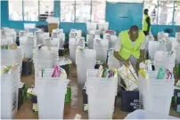  ?? AFP ?? Kenya’s Independen­t Electoral and Boundaries Commission officials arrange electoral material at a centre in Nairobi. —