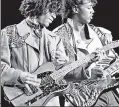  ??  ?? PURPLE PAIN: Former Revolution bassist BrownMark (above right, with Prince) writes in his new book about being cheated out of money and songwritin­g credit by his music-superstar boss.