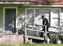  ?? Bob Owen / Staff photograph­er ?? Cpl. Victor Mata of the Balcones Heights Police Department walks up to visit with Peggy Brown, part of the department’s plan to check on every resident in the city amid a stay-at-home order.