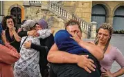  ?? Samuel Aranda / New York Times ?? Relatives of the men who allegedly carried out the attacks in Barcelona and Cambrils gather with other Muslims in the main square of Ripoll, Spain.