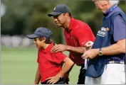  ?? AP PHOTO BY SCOTT AUDETTE ?? Tiger Woods, right, talks with his son Charlie Woods on the second green during the second round of the PNC Championsh­ip golf tournament Sunday, Dec. 19, 2021, in Orlando, Fla.