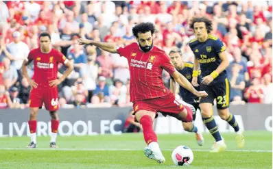  ?? AP ?? Liverpool’s Mohamed Salah scores his side’s second goal of the game from the penalty spot during their English Premier League match against Arsenal at Anfield, Liverpool, yesterday.