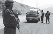  ?? THE ASSOCIATED PRESS ?? Afghan police officers search a vehicle at a checkpoint on the Ghazni highway, in Maidan Shar, west of Kabul, Afghanista­n on Monday.