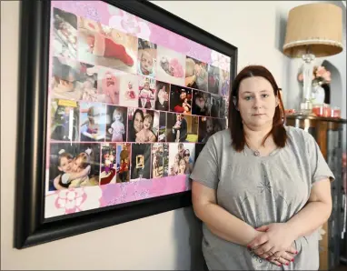  ?? NICK CAMMETT — THE ASSOCIATED PRESS ?? Jessica Day-Weaver poses next to a picture collage made for her daughter, Anastasia, at her home, Thursday, Feb. 2, 2022, in Boardman, Ohio.