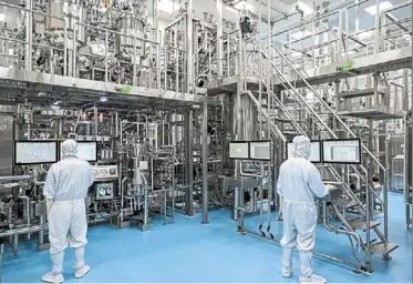  ?? — AFP ?? New opportunit­ies: Workers inside the Serum Institute of India in hadapsar, Pune. The new trade agreement is set to boost exports of pharmaceut­icals, garments, chemicals and machinery.