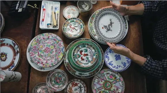  ?? (AP/KIN Cheung) ?? Joseph Tso, owner of Yuet Tung China Works, Hong Kong’s last hand-painted porcelain factory, holds a plate with dragon print June 8 in Hong Kong.