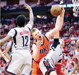  ??  ?? Oklahoma City Thunder's Domantas Sabonis (3) battles for a rebound with Houston Rockets' Lou Williams (12) and Sam Dekker (7) in the first half of their NBA game in Houston on Sunday. (AP)