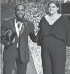  ??  ?? PJ Morton, left, and Yebba accept the award for Best Traditiona­l R&amp;B Performanc­e for “How Deep Is Your Love.” ROBERT HANASHIRO/USA TODAY