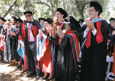  ?? Photos by Brant Ward / The Chronicle ?? Graduates of Stanford’s Graduate School of Education applaud as Bonnie Gould accepts his degree.