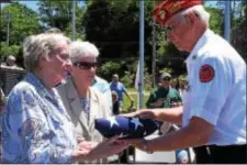  ?? ANNE NEBORAK – DIGITAL FIRST MEDIA ?? Dorothy Bierman of Norwood and Sister Catherine Shanahan of Glenolden receive a flag from Benjamin Sides of the Smedley Butler Marine Corps League. The flag is for their brother, Joseph Shanahan.