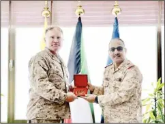  ?? MoD photo ?? Major General Christophe­r McPhillips is presented a memento.