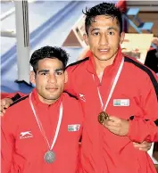  ??  ?? Mohammed Hussamuddi­n (left) and Kavindra Singh Bist pose with their medals at Gee Bee Boxing Tournament.