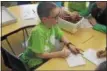  ??  ?? Andrew Miller, 8, was one of several students at Milton Terrace Elementary who made a difference Wednesday.