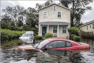  ?? VICTOR J. BLUE / NEW YORK TIMES ?? Rising floodwater­s ravage vehicles and homes Saturday in New Bern, N.C. Warnings of flash floods remain as rivers swell with rain predicted to keep falling.