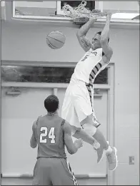  ?? Arkansas Democrat-Gazette/THOMAS METTHE ?? Little Rock Hall’s Gregory Johnson dunks for 2 of his 22 points in the Warriors’ 60-56 victory over Little Rock Parkview at Cirks Arena in Little Rock on Friday night.