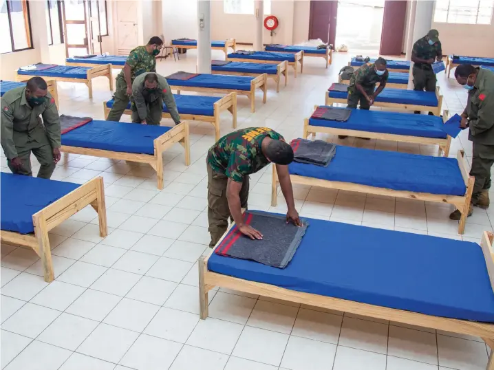  ?? Photo: Leon Lord ?? Republic of the Military Forces personnel set up beds on July 8, 2021 at the Patel Samaj Hall in Toorak, Suva, as they prepare for the influx of COVID-19 patients.