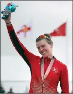  ??  ?? The Associated Press
Joanna Brown celebrates after receiving her bronze medal in the women’s triathlon at the 2018 Commonweal­th Games in Australia.