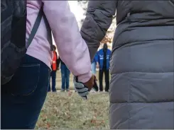  ?? Associated Press ?? ■ Students and community members hold hands in prayer before classes Wednesday at Paducah Tilghman High School in Paducah, Ky. The gathering was held for the victims of the Marshall County High School shooting Tuesday.