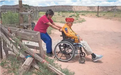  ?? PHOTOS BY MARK HENLE/THE REPUBLIC ?? Shaylee Vandever pulls her grandfathe­r, Navajo Code Talker Joe Vandever Sr., up the driveway on July 12, 2019, at their home in Haystack, New Mexico.