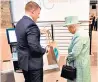  ??  ?? Beware the bagging area: the Queen is left politely confused