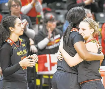  ?? JONATHAN NEWTON/THE WASHINGTON POST ?? Maryland’s Kristen Confroy, right, hugs Brianna Fraser after the Terps’ loss as Eleanna Christinak­i looks on. Maryland, which trailed by as many as 18 in the third quarter, cut its deficit to two points in the fourth quarter before falling to the...