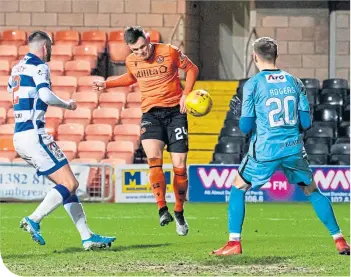  ??  ?? Lawrence Shankland heads home to rescue a point for the leaders in the final minute