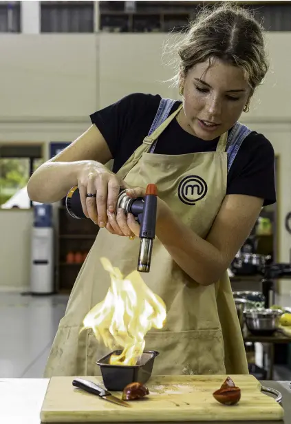  ?? PHOTO: WARNER BROS DISCOVERY NEW ZEALAND ?? All fired up . . . After finishing third in the MasterChef New Zealand television show, University of Otago politics master’s student Alice Taylor is living her dream, working as a commis chef in a highend Auckland restaurant.