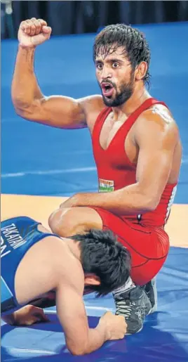  ??  ?? Bajrang Punia gestures defeating Japan's Daichi Takatani in the 65kg wrestling final on Sunday.