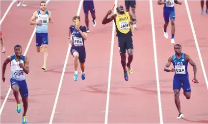  ?? AP FOTO ?? SAD ENDING. Usain Bolt pulls up injured while running the final leg for Jamaica in the 4x100 final.