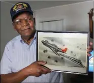  ?? DAILY TIMES ?? William Rice holds up an image of a P-51Mustang he flew as part of the Tuskegee Airmen in World War II for a story on him in 2012.