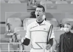  ?? CLIVE BRUNSKILL/GETTY IMAGES ?? Top-ranked Novak Djokovic of Serbia celebrates after defeating Spain’s Pablo Carreno Busta 4-6, 6-2, 6-3, 6-4 in a quarterfin­al of the French Open at Roland Garros. Djokovic next will meet Greece’s Stefanos Tsitsipas on Friday.