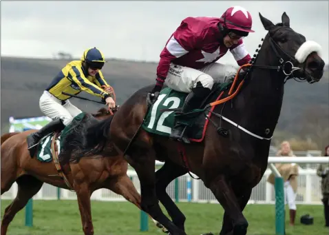  ??  ?? Champagne Classic and J.J. Slevin on their way to winning the Martin Pipe Conditiona­l Jockeys’ Handicap Hurdle on St. Patrick’s Day.