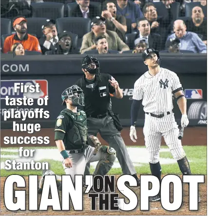  ?? Robert Sabo ?? STAN’ THE MAN: Giancarlo Stanton — and a slew of amazed Yankees fans behind him — watch his moon-shot home run in the bottom of the eighth inning of Wednesday’s 7-2 wild-card win over the Athletics.