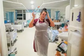  ??  ?? A nurse who has been treating Covid-19 patients on one of the amber wards at University Hospital in Coventry. Photograph: Jonny Weeks/The Guardian