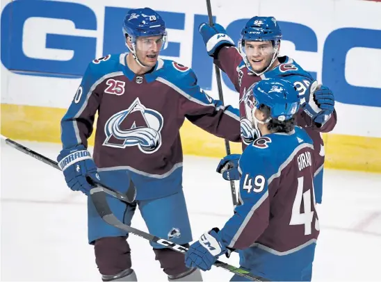  ?? Andy Cross, The Denver Post ?? Avalanche left wing Andre Burakovsky, center, celebrates his first period goal against the St. Louis Blues with teammates Brandon Saad, left, and Samuel Girard in the first period at Ball Arena on Wednesday night,.