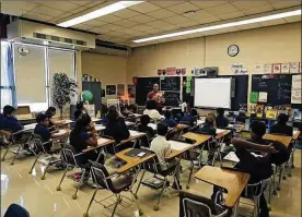  ?? KYLE ROBERTSON / COLUMBUS DISPATCH ?? An air conditioni­ng unit (top left) was added to this sixth-grade classroom at Sherwood Middle School in Columbus as part of Operation: Fix It, a five-year, $125 million plan to repair buildings that range from 40 to 100 years old.