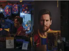  ?? MORENATTI
AP PHOTO/EMILIO ?? A poster with the face of Barcelona soccer player Lionel Messi is displayed at a F.C. Barcelona store in Barcelona, Spain on Tuesday.