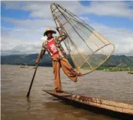  ?? KATIE ARNOLD/PRI’S THE WORLD ?? Inle Lake’s traditiona­l fishermen now make more money performing for tourists than actually fishing.