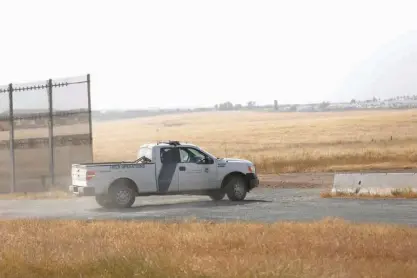  ?? San Diego Union Tribune via TNS ?? n A Customs and Border Protection truck patrols the border fence east of Otay Mesa outside San Diego in April. In January, President Donald Trump vowed to hire 5,000 new Border Patrol agents, but the number of officers have dropped by 220 in seven...