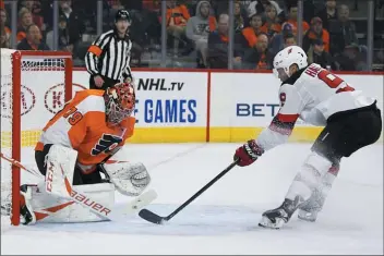  ?? TOM MIHALEK – THE ASSOCIATED PRESS ?? Flyers goalie Carter Hart, left, stops a shot by New Jersey Devils’ Taylor Hall. The Flyers this year will offer their fans a ‘rage room’ in which they can work off their frustratio­ns.