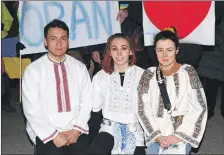  ?? Photograph: Kevin McGlynn and right, Alan Windram ?? Valeriia Samoilenka, right, Kateryna Campbell, centre, and her partner Jamie MacKay dressed in traditiona­l Ukranian national dress at the vigil at Station Square, Oban on Sunday evening, right.